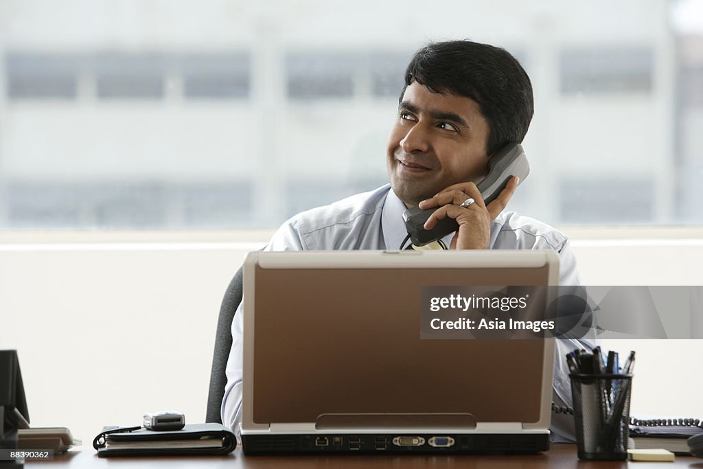 Business man talking on office phone