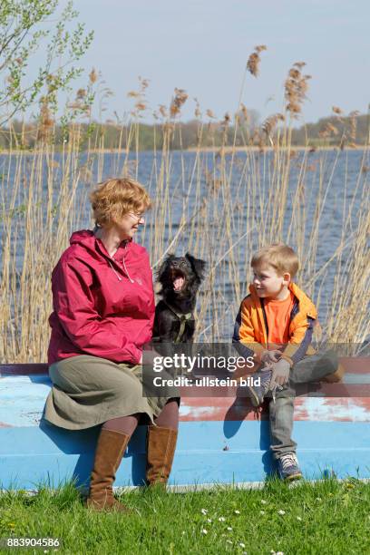 Mother, son and dog having a break beside Schaalsee