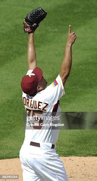 Venezuela's pitcher Francisco Rodriguez reacts to the win over The Netherlands and points skyward during the Pool 2 Game 1, of the second round of...