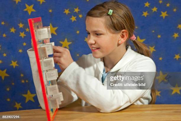 Girl opening a door of her Advent calendar