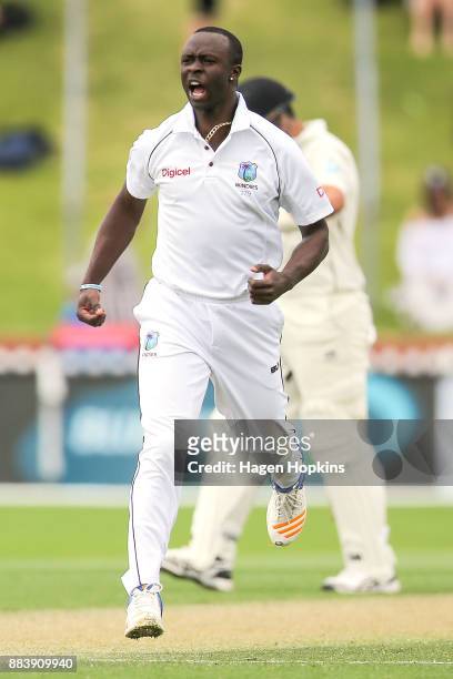 Kemar Roach of the West Indies celebrates after taking the wicket of Jeet Raval of New Zealand during day two of the Test match series between New...