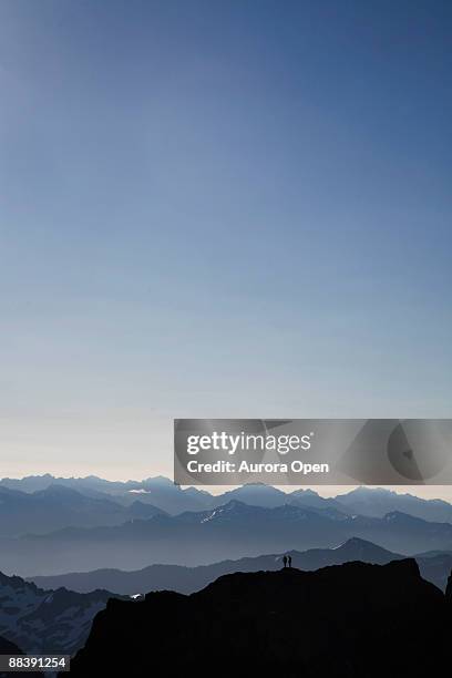 climbers stand on a false summit while climbing a mountain in olympic national park,wa. - mount-olympus-olympic-national-park stock pictures, royalty-free photos & images