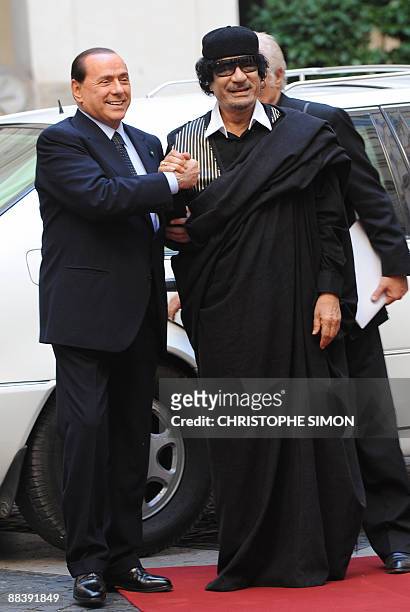 Libya's leader Moamer Kadhafi is greeted by Italian Prime Minister Silvio Berlusconi upon arrival for their meeting on June 10, 2009 at the Palazzo...