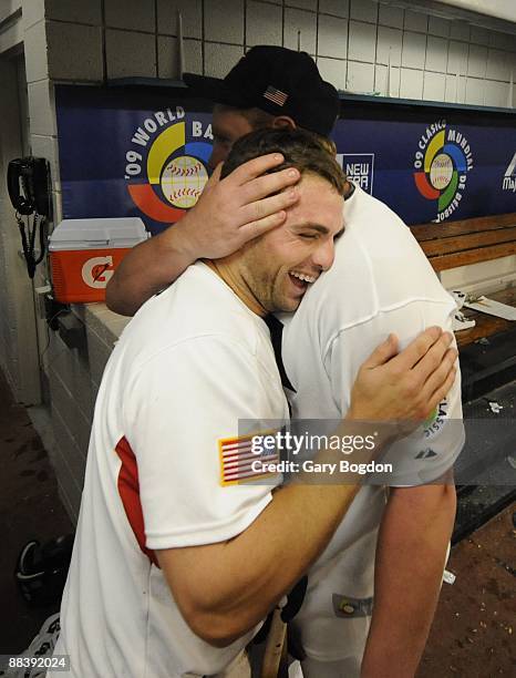 Team USA's David Wright is hugged by teammates after their win over Puerto Rico during the Pool 2 Game 5, of the second round of the 2009 World...