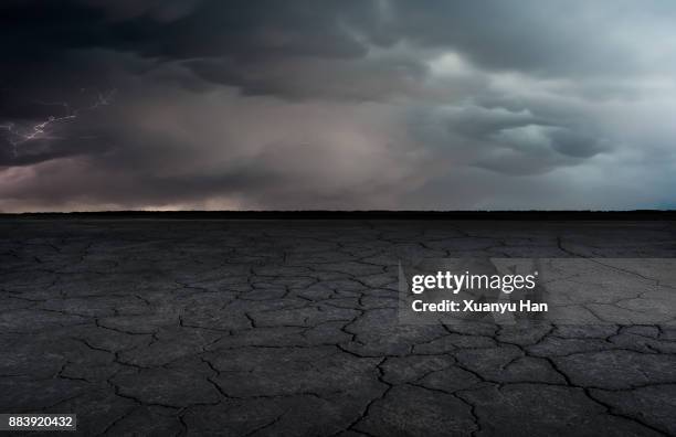 a dry lakebed landscape under the lightning bolts ,auto advertising background - árido fotografías e imágenes de stock