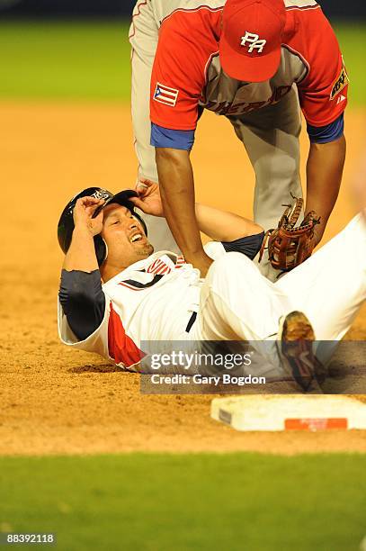 Puerto Rico's Carlos Delgado tags Team USA's Shane Victorino at first base during the Pool 2 Game 5, of the second round of the 2009 World Baseball...