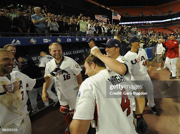 Team USA's David Wright is hugged by teammates after their win over Puerto Rico during the Pool 2 Game 5, of the second round of the 2009 World...