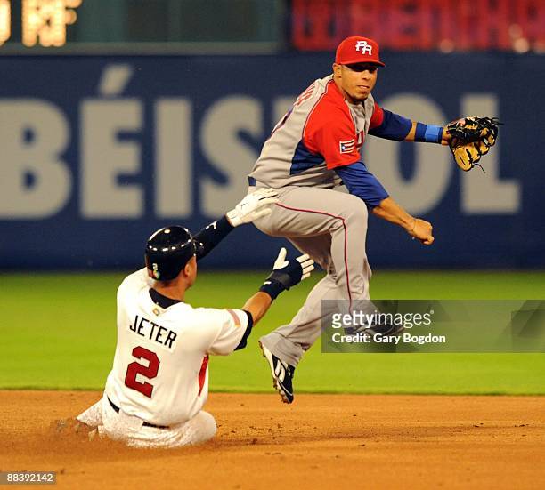 Team USA's Derek Jeter is out as Puerto Rico's Mike Aviles makes a double play during the Pool 2 Game 5, of the second round of the 2009 World...