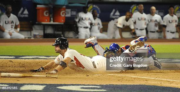 Team USA's David Wright slides safely into homeplate and scores as Puerto Rico's catcher Geovany Soto tries in vain to make the tag during the Pool 2...