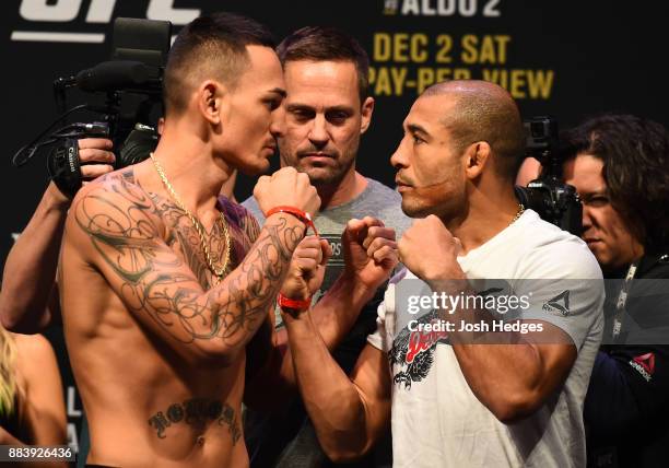Max Holloway and Jose Aldo of Brazil face off during the UFC 218 weigh-in inside Little Caesars Arena on December 1, 2017 in Detroit, Michigan.