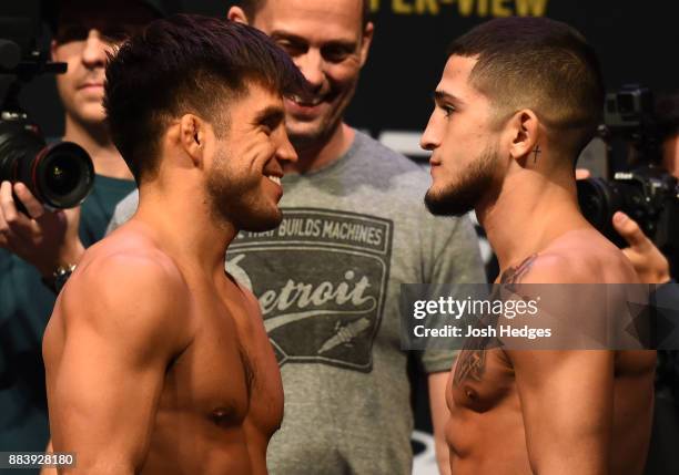 Henry Cejudo and Sergio Pettis face off during the UFC 218 weigh-in inside Little Caesars Arena on December 1, 2017 in Detroit, Michigan.