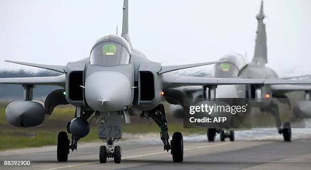 Saab JAS 39 Gripen fighter aircraft taxi out for start during the NATO exercise Loyal Arrow outside Lulea in northern Sweden, on June 10, 2009. Some...