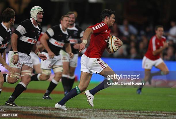 Mike Phillips, the Lions scrumhalf breaks away to score the second try during the match between the Sharks and the British and Irish Lions on their...