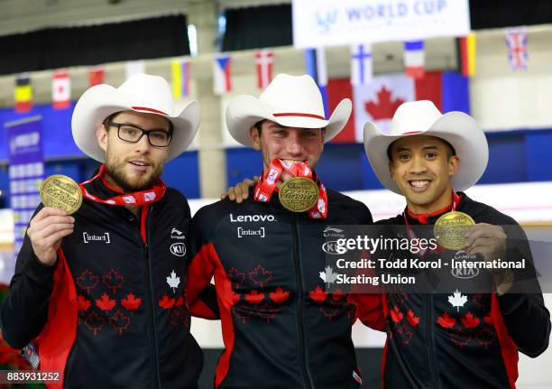 Team Canada members Laurent Dubreuil , Vincent De Haitre and Gilmore Junio celebrate their first place finish and new world record in the team sprint...