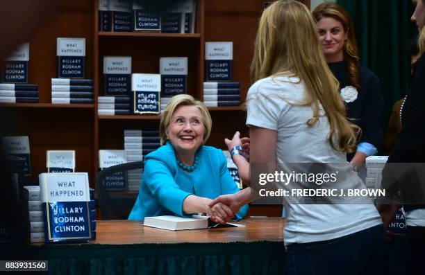 Hillary Clinton greets supporters, getting a signed copy of Clinton's book "What Happened", at Vroman's Bookstore in Pasadena, California on December...