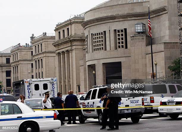 Police gather in front of the Holocaust Museum following a shooting at the museum June 10, 2009 in Washington, DC. According to reports, James van...