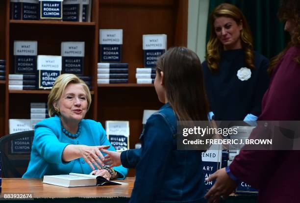 Hillary Clinton greets supporters, getting a signed copy of Clinton's book "What Happened", at Vroman's Bookstore in Pasadena, California on December...