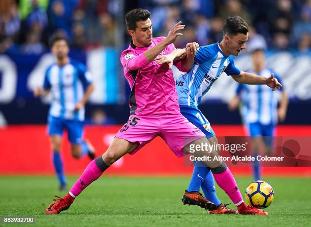 Mitchell James Langerak of Levante UD competes for the ball with Juan Pablo Anor "Juanpi" of Malaga CF during the La Liga match between Malaga and...