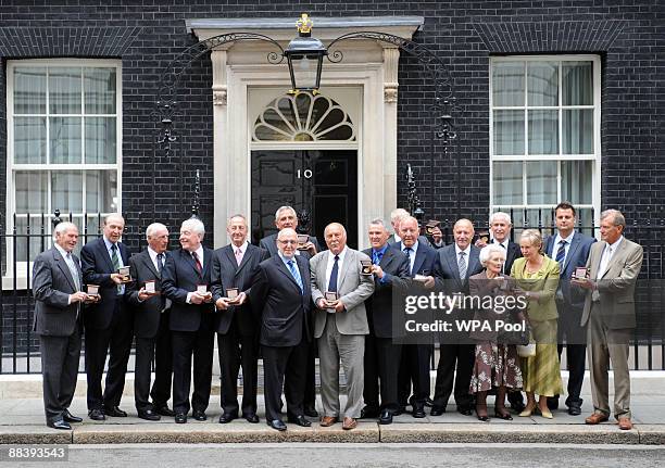 Jimmy Greaves stands with Chairman of the Football Association Geoff Thompson in front of the other recipients of medals presented by Prime Minister...
