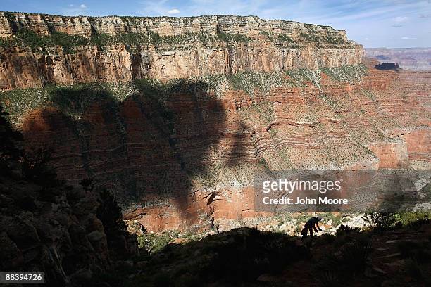 National Park Service trail crew member Adam Gibson repels down the side of a cliff while repairing a trail on June 10, 2009 in the Grand Canyon...