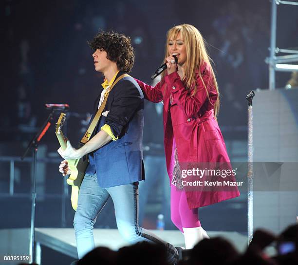 Nick Jonas of the Jonas Brothers and Miley Cyrus perform during her "Best of Both Worlds" tour at Nassau Coliseum on December 27, 2009 in Uniondale,...