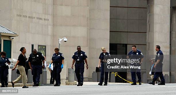 Investigators search for evidence on 14th Street outside the U.S. Holocaust Memorial Museum after a shooting happened in the museum June 10, 2009 in...