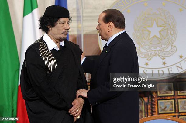 Libya's leader Muammar Gaddafi attends a meeting with Italian Prime Minister Silvio Berlusconi at Villa Madama on June 10, 2009 in Rome,...