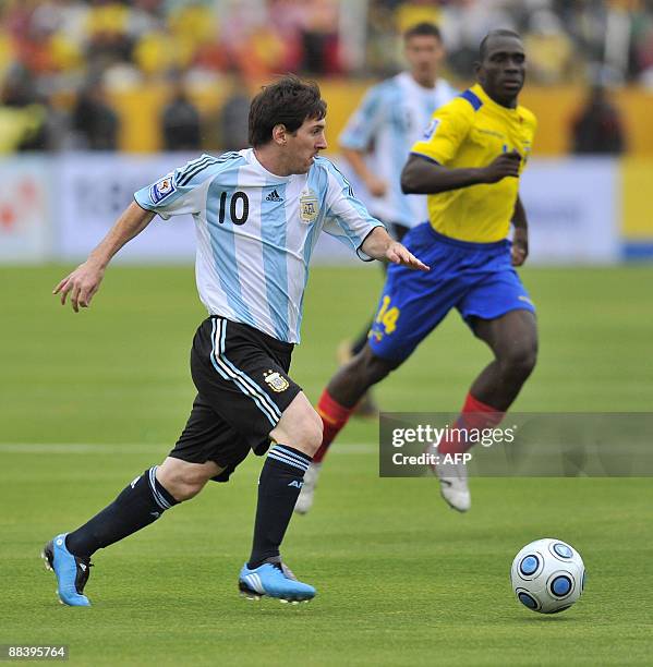 Argentine forward Lionel Messi controls the ball near Ecuadorean defender Walter Ayovi during their FIFA World Cup South Africa-2010 qualifier...