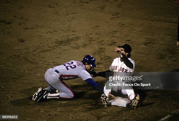 Infielder Ray Knight of the New York Mets is safe at first base beating the throw to first baseman Bill Buckner of the Boston Red Sox in a 1986 World...