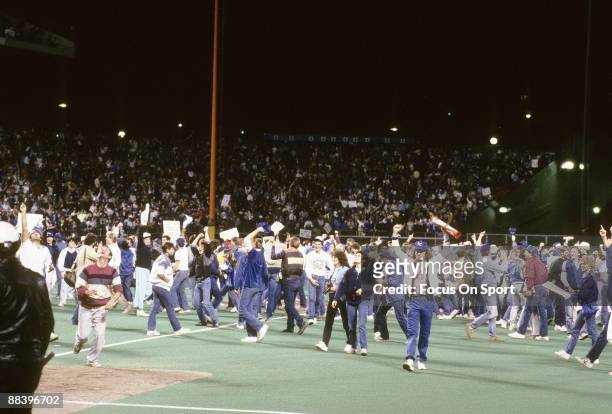 Kansas City Royals' fans run on to the field in jubilation after the Royals defeated the St. Louis Cardinals in game seven of the World Series,...