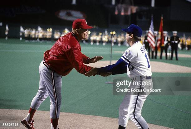 Managers Whitey Herzog of the St. Louis Cardinals and Dick Howser of the Kansas City Royals shake hands prior to the start of a World Series game...