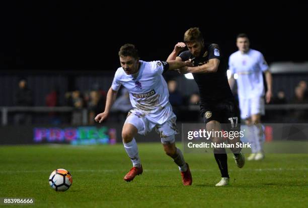 Sam Finley of AFC Fylde and Michael Jacobs of Wigan Athletic gin action during The Emirates FA Cup Second Round match between AFC Fylde and Wigan...