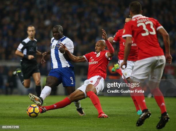 Porto forward Vincent Aboubakar from Cameroon tackled by SL Benfica defender Luisao from Brazil during the Primeira Liga match between FC Porto and...