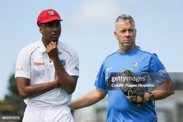 Miguel Cummins and coach Stuart Law of the West Indies look on during day two of the Test match series between New Zealand Blackcaps and the West...