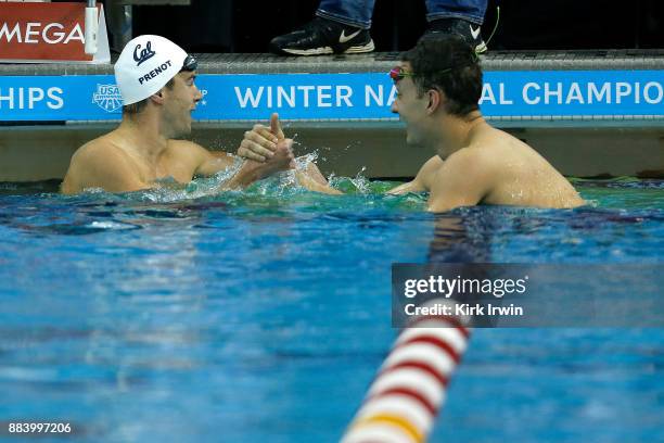 Josh Pernot of California Aquatics is congratulated by Michael Salazar of Ohio Sate University after winning the A-Final of the men's 100 yard...