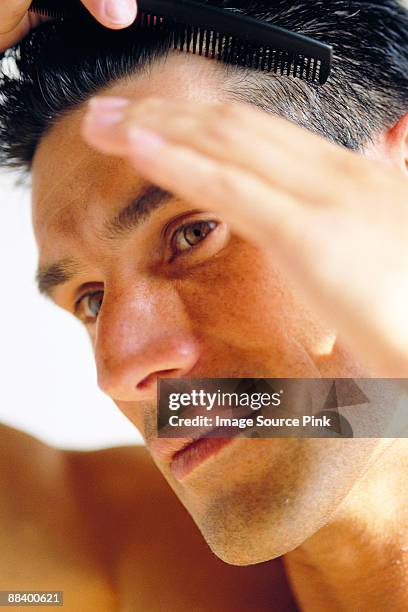 combing hair - man combing hair stock pictures, royalty-free photos & images