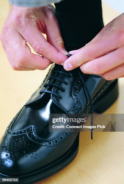 tying shoe laces - lace fastener stock-fotos und bilder