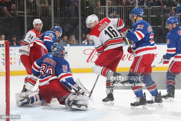 Henrik Lundqvist of the New York Rangers makes a save past the screen of Marcus Kruger of the Carolina Hurricanes at Madison Square Garden on...