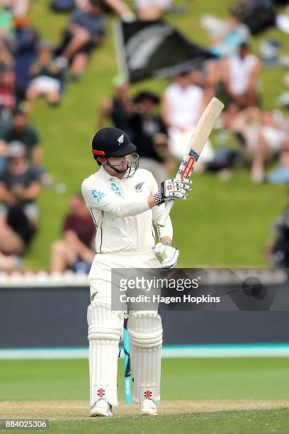 Henry Nicholls of New Zealand acknowledges his half century during day two of the Test match series between New Zealand Blackcaps and the West Indies...