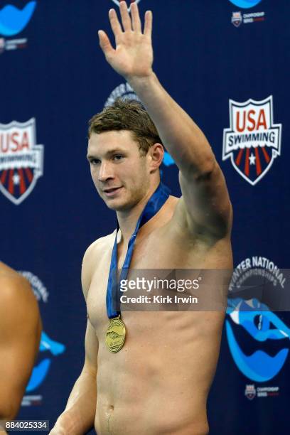 Ryan Murphy of California Aquatics waves to the crowd after receiving his gold medal for winning the A-Final of the men's 100 yard backstroke during...