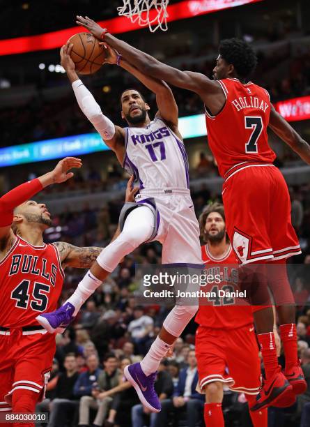 Garrett Temple of the Sacramento Kings puts up a shot between Denzel Valentine and Justin Holiday of the Chicago Bulls at the United Center on...