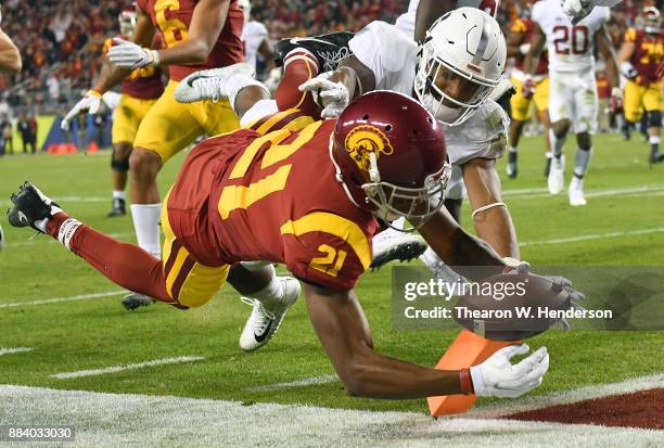 Tyler Vaughns of the USC Trojans dives into the endzone for a touchdown against the Stanford Cardinal during the Pac-12 Football Championship Game at...