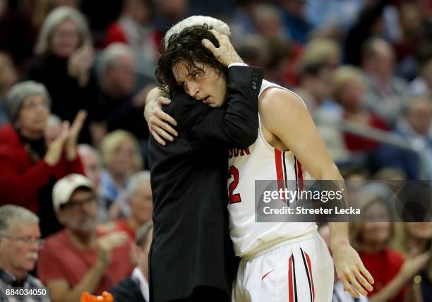 Head coach Bob McKillop of the Davidson Wildcats talks to Rusty Reigel during their game against the North Carolina Tar Heels at Spectrum Center on...