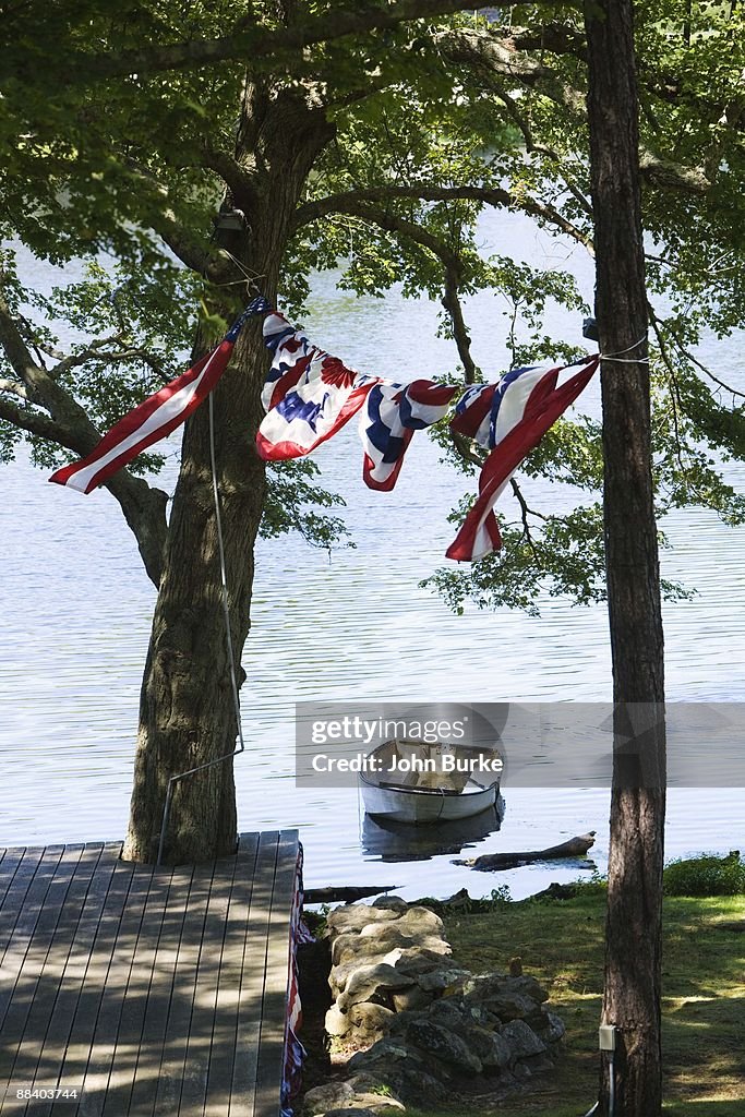 American flag banner hanging over dock and boat in water, Cape Cod, Massachusetts