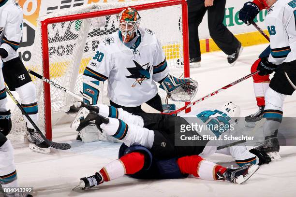 Goaltender Aaron Dell of the San Jose Sharks defends while teammate Joel Ward tangles with Aleksander Barkov of the Florida Panthers at the BB&T...