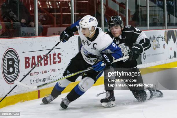 Joe Veleno of the Saint John Sea Dogs battles for the puck against Gabriel Bilodeau of the Gatineau Olympiques on December 1, 2017 at Robert Guertin...