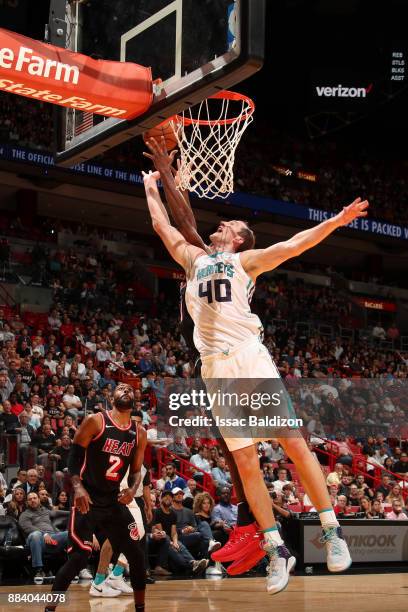 Cody Zeller of the Charlotte Hornets goes for the rebound against the Miami Heat on December 1, 2017 at American Airlines Arena in Miami, Florida....