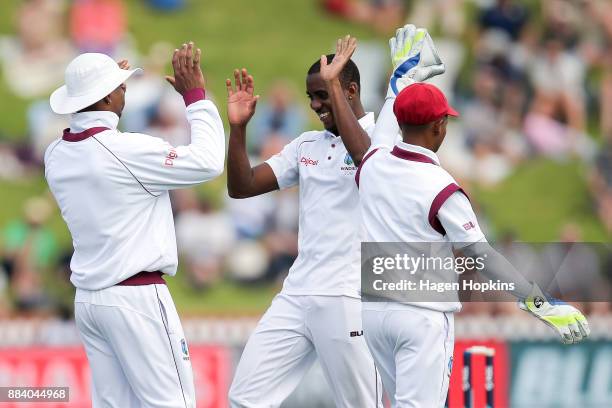 To R, Roston Chase, Miguel Cummins and Shane Dowrich of the West Indies celebrate the wicket of Mitchell Santner of New Zealand during day two of the...