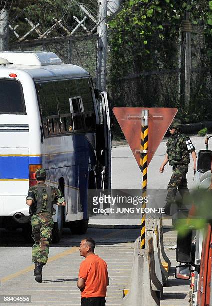 South Korean soldiers check the bus carrying a delegation led by Kim Young-Tak, director general of the Kaesong Industrial Complex Project Bureau...