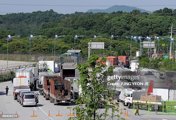 South Korean vehicles wait to head for the Kaesong Industrial Complex at a check point of the inter-Korea transit office in Paju near the...